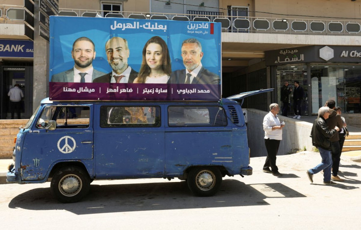 A billboard of Sara Zaiter, a french professor who is running as an opposition candidate in Lebanon's parliamentary election, and members of her electoral list is on a vehicle, in Baalbeck, Lebanon May 8, 2022.