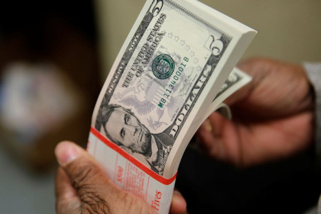 A packet of U.S. five-dollar bills is inspected at the Bureau of Engraving and Printing in Washington March 26, 2015. 
