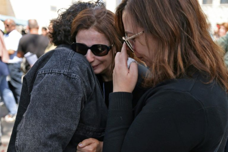 Mourners react as Abu Akleh's body arrives at a hospital in the east Jerusalem neighbourhood of Sheikh Jarrah, on May 12, 2022