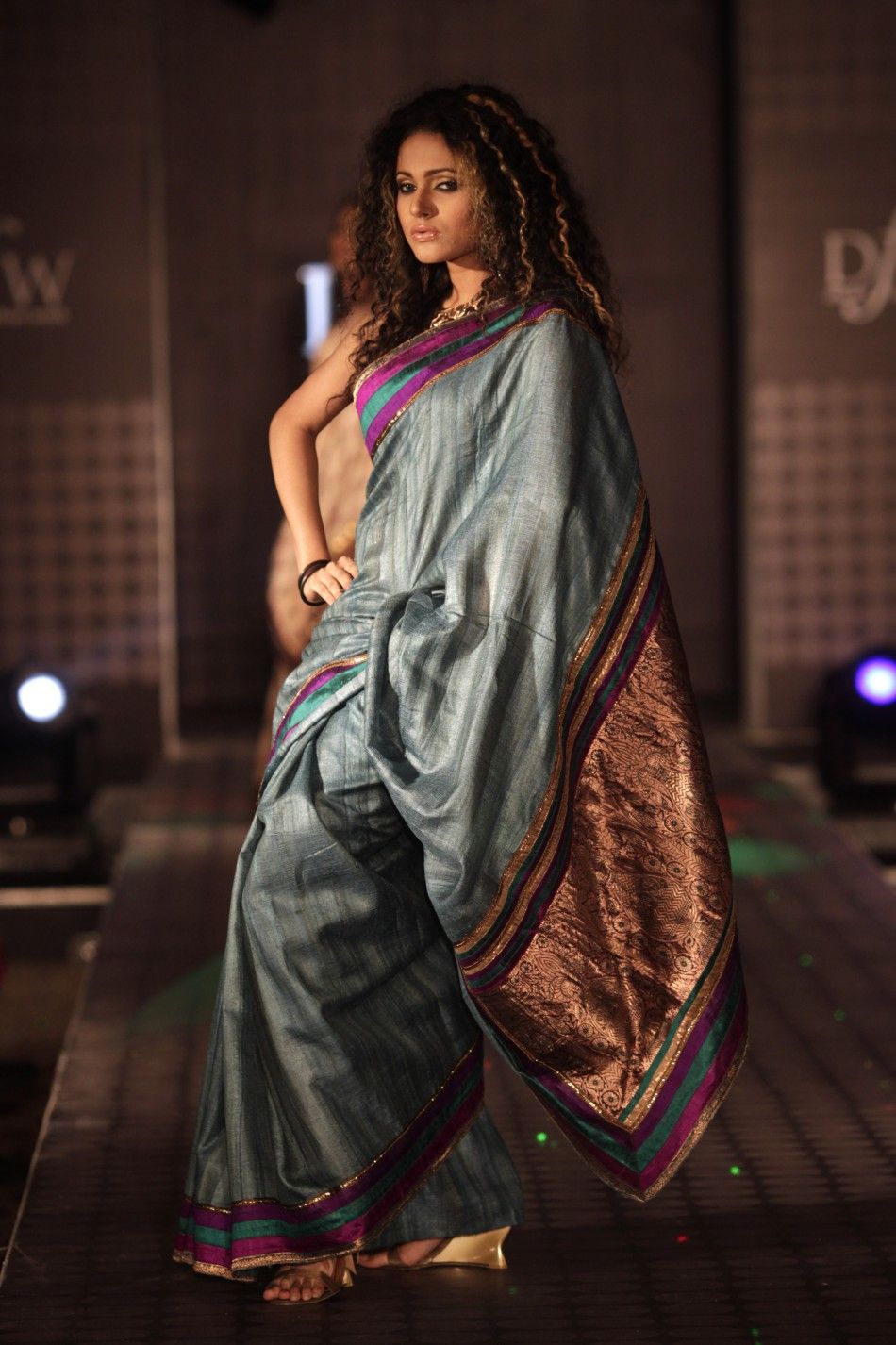 Models showcase creations by Bangladeshi fashion label Mansha during Dhaka Fashion Week