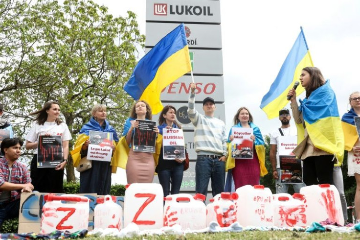 Demonstrators demanding a boycott of Russian oil outside the Brussels offices of energy giant Lukoil