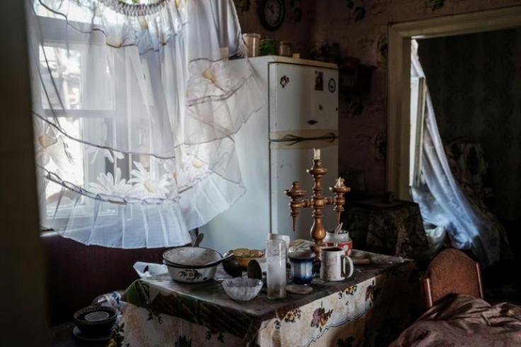 Some cottages in an abandoned village along the east Ukrainian front still have meals on their tables and other signs of people fleeing in a rush