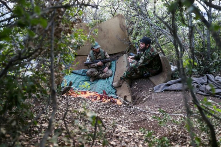 Fighters affiliated with the Hayat Tahrir al-Sham (HTS) jihadist group take a position in the mountainous northern countryside of Syria's northwestern Latakia province on April 23, 2022