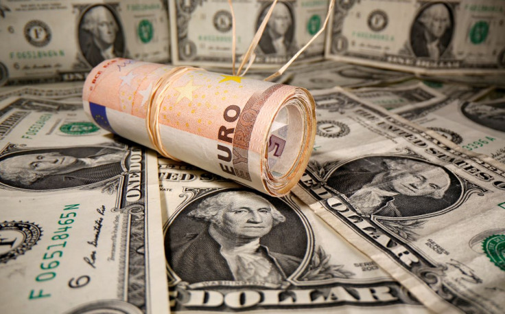 Rolled Euro banknotes are placed on U.S. Dollar banknotes in this illustration taken May 26, 2020.