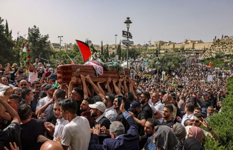 Palestinian mourners carry the casket of slain  Al Jazeera journalist Shireen Abu Akleh at her funeral in Jerusalem