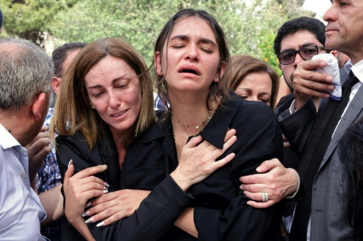 Mourners pay their last respects to Abu Akleh as she is buried