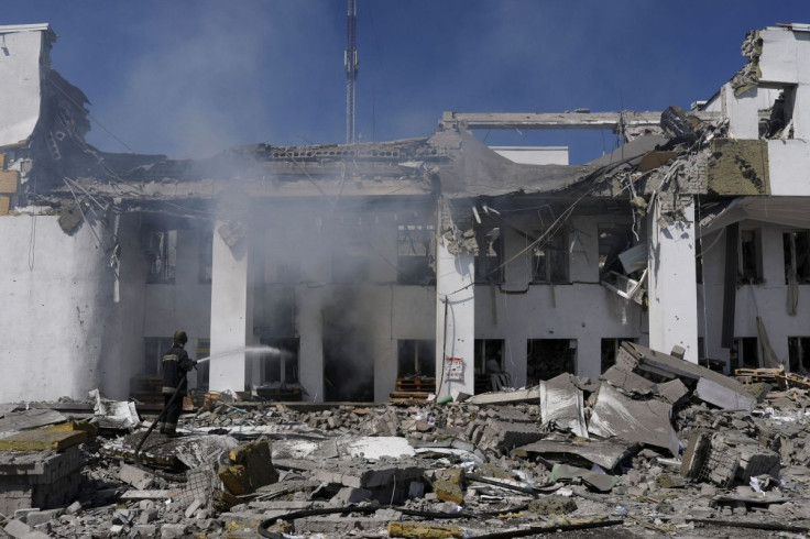 A firefighter works to extinguish a fire after a Russian bombing hit the House of Culture, which was used to distribute aid, amid Russia's attack on Ukraine, in Derhachi near Kharkiv, Ukraine, May 13, 2022. 