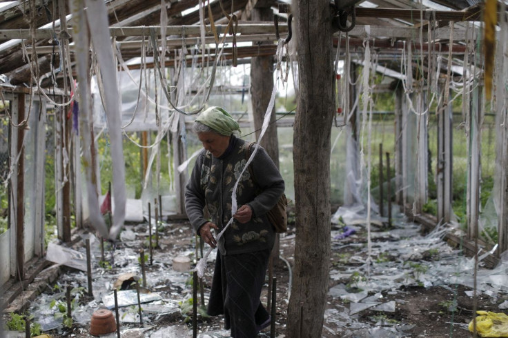 Vera Kosolopenko, reacts while looking at her destroyed greenhouse, after her house and property were hit by Russian bombing, amid Russia's attack on Ukraine, in the village of Berzuky, Derhachi district, Kharkiv region, Ukraine, May 14, 2022.