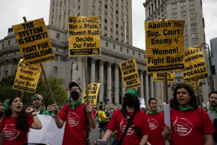 Demonstrators wield signs during the abortion rights rally, part of a national day of action