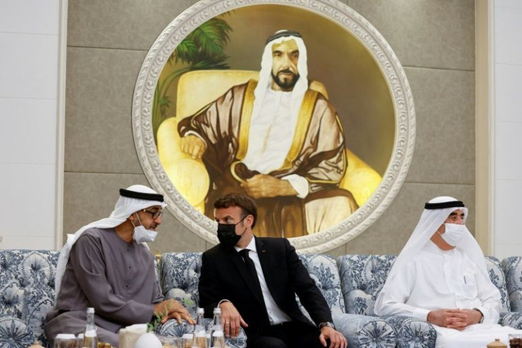 French President Emmanuel Macron, at the centre, meets the newly-elected president of the United Arab Emirates, Sheikh Mohammed bin Zayed Al Nahyan, on the left, at Al Mushrif Palace in Abu Dhabi on May 15, 2022