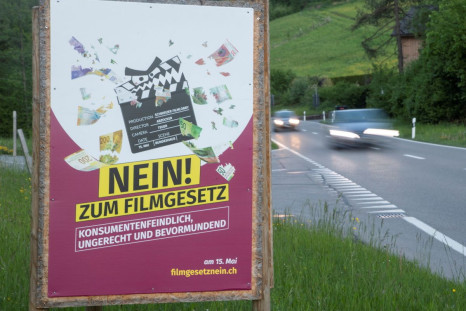 A poster reading: "No to the film law - anti-consumer, unfair, patronising" is seen on a field, before the Swiss electorate votes on several issues in a referendum next weekend, near Birmensdorf, Switzerland May 9, 2022. Picture taken May 9, 2022. 