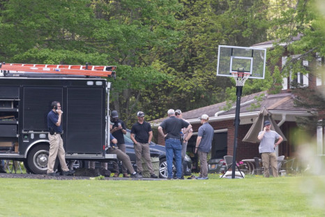 Law enforcement personnel stand outside the home of Buffalo supermarket shooting suspect Payton Gendron in Conklin, New York, U.S. May 15, 2022.  