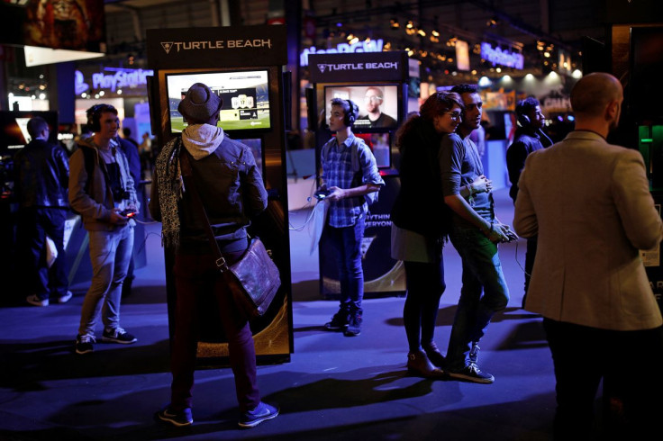 Visitors play video games with Turtle Beach headphones at the Paris Games Week, a trade fair for video games in Paris, France, October 26, 2016.