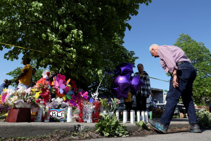A man looks a memorial for victims near the scene of a shooting at a TOPS supermarket in Buffalo, New York, U.S. May 15, 2022. 
