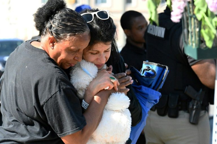 People mourn near a Tops Grocery Store in Buffalo, New York on May 15, 2022