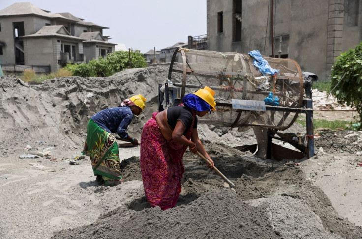 Labourers work at a construction site on a hot summer day in Noida, India, May 12, 2022.