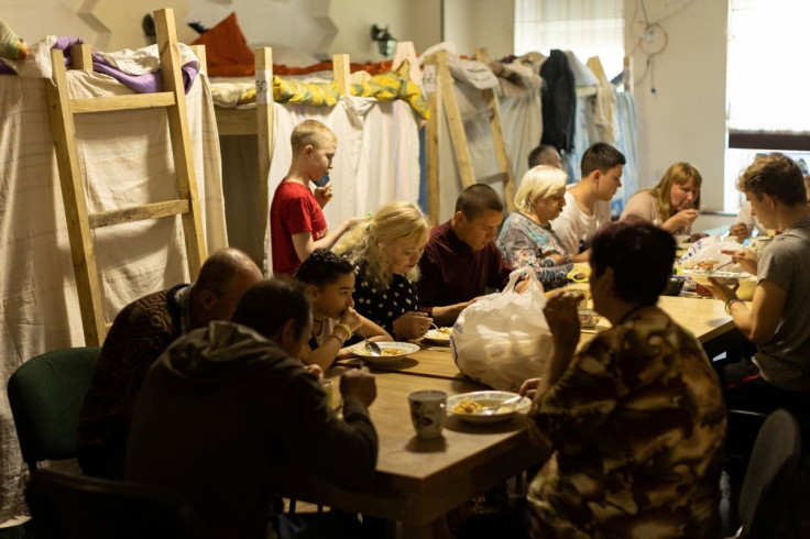 Internally displaced people from the Donbas region have a meal provided by the NGO World Central Kitchen, in a refugee shelter organized in a former coffee shop, amid Russia's invasion of Ukraine, in Dnipro, Ukraine May 14, 2022.