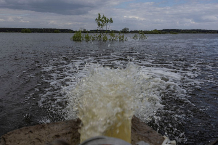 Water is seen pumped from flooded area after Ukrainian military forces opened a dam to flood an residencial area in order to stop advance of Russian forces to arrive to the capital city of Kyiv, in Demydiv, Ukraine, May, 15, 2022. 