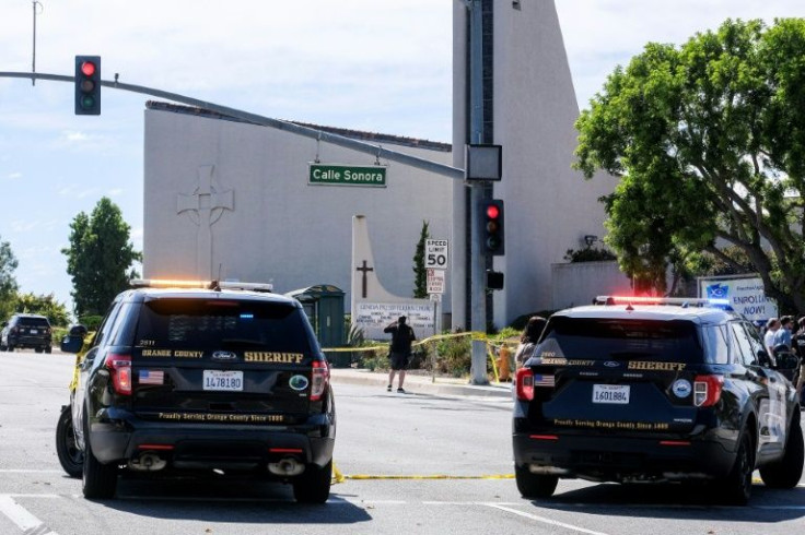 Police vehicles are seen after a shooting inside Geneva Presbyterian Church in Laguna Woods, California, on May 15, 2022