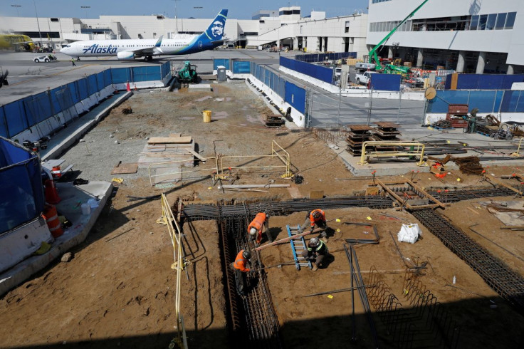 Workers prepare a cabling trench at a construction site at Los Angeles International Airport (LAX) in Los Angeles, California, U.S., March 30, 2022. Picture taken March 30, 2022.  