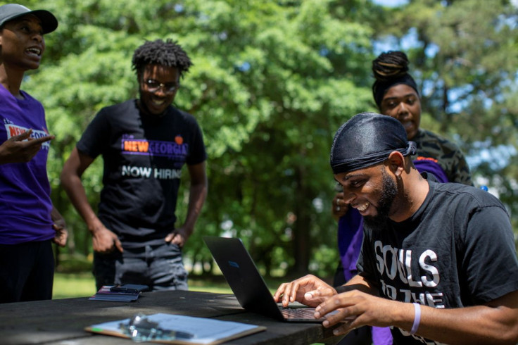 Jon Luke Young, manager for the Get Out the Vote department of the New Georgia Project, speaks with canvassers while assigning them routes to knock on doors in Fulton County to encourage people to register to vote in Atlanta, Georgia, U.S., May 12, 2022. 