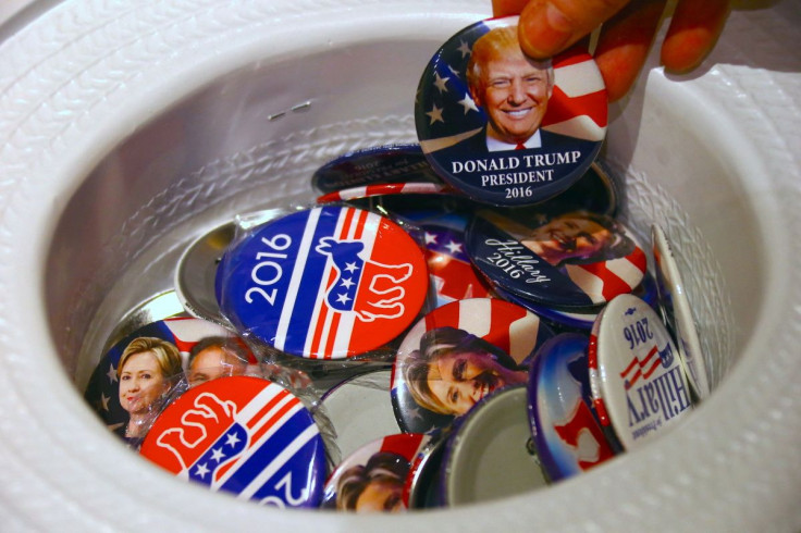 A guest at an event called the U.S. Presidential Election Watch, organised by the U.S. Consulate, reaches for a badge from out of a hat displaying photographs of Republican candidate Donald Trump and Democratic candidate Hillary Clinton, in Sydney, Austra