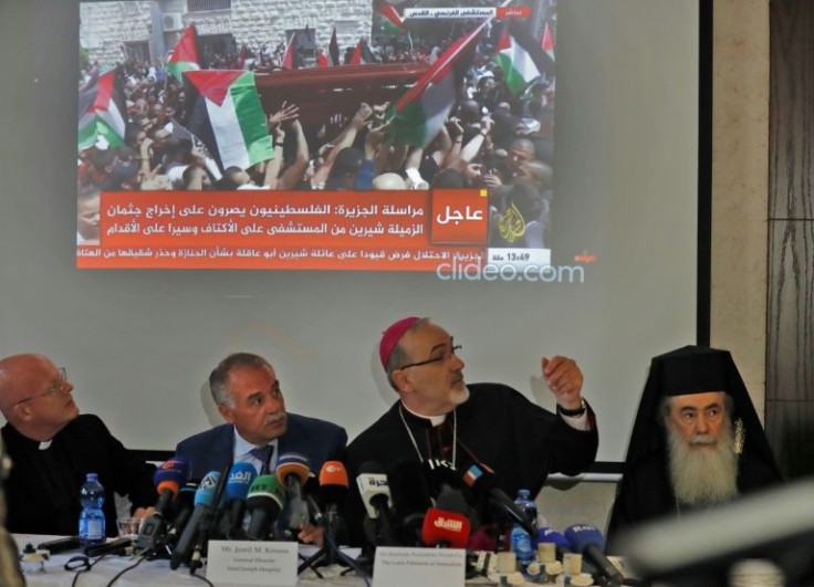 Latin Patriarch of Jerusalem Pierbattista Pizzaballa, at the centre, speaks at a press conference, joined by the Greek Orthodox Patriarch of Jerusalem Theophilos III, right, and the General Director of Saint Joseph Hospital Jamil Koussa