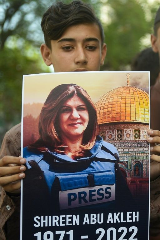 Slain journalist Shireen Abu Akleh seen on a poster held at a rally in Karachi, Pakistan by the Supporters of Palestine Foundation Pakistan, on May 15, 2022