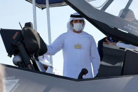 Sheikh Hamdan bin Mohammed bin Rashid Al-Maktoum, Crown Prince of Dubai, inspects the open cockpit of an F-35 Lightning II multirole combat aircraft during the 2021 Dubai Airshow in the Gulf emirate on November 14, 2021