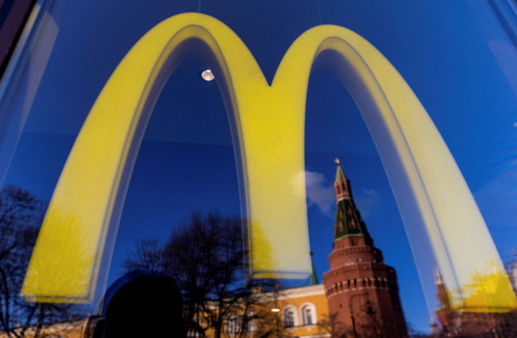 A logo of the McDonald's restaurant is seen in the window with a reflection of Kremlin's tower in central Moscow, Russia March 9, 2022. 