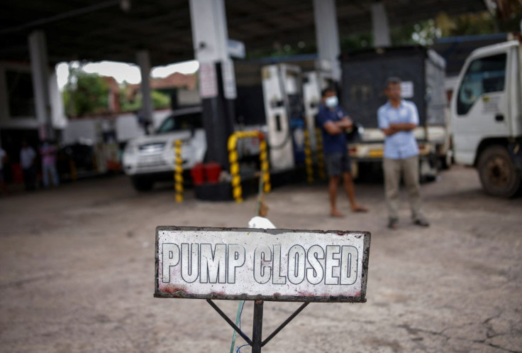 People wait in a queue to buy petrol at a closed fuel station, amid the country's economic crisis in Colombo, Sri Lanka, May 16, 2022. 