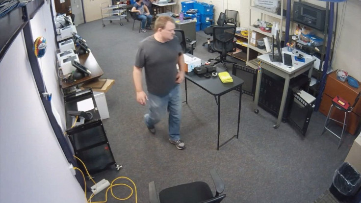 Elbert County Clerk, Dallas Schroeder, is seen inside his office in Elbert County, Colorado, U.S., August 26, 2021, in this frame grab from surveillance footage that showed him copying sensitive voter information. Still image from video taken August 26, 2