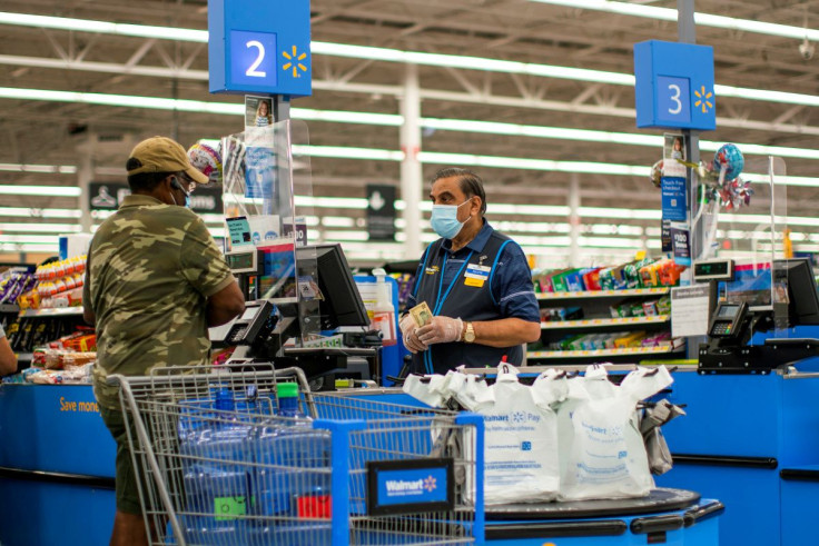 A worker and a shopper are seen wearing masks at a Walmart store, in North Brunswick, New Jersey, U.S. July 20, 2020.