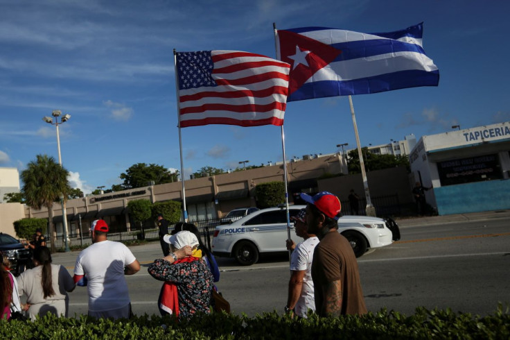 Emigres wave American and Cuban flags outside Versailles restaurant, in reaction to reports of protests in Cuba against its deteriorating economy, in Miami, Florida, U.S. July 18, 2021.