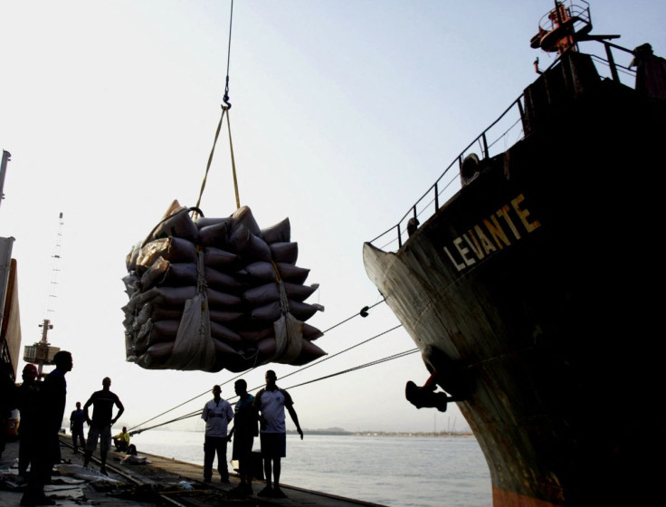 Port workers watch as a crane lifts sugar sacks on the docks at Brazil's main ocean port, in Santos, in this picture taken on September 3, 2004.