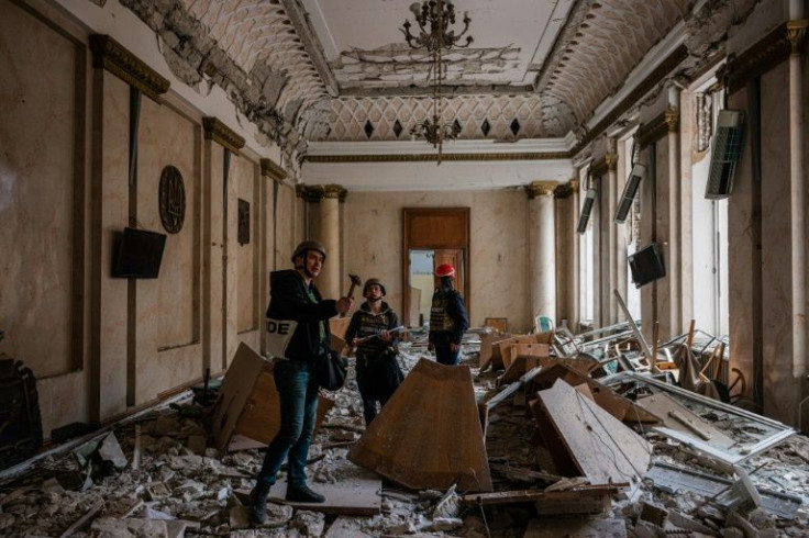 Helmeted architects and experts sporting bullet-proof vests are already assessing the local government headquarters