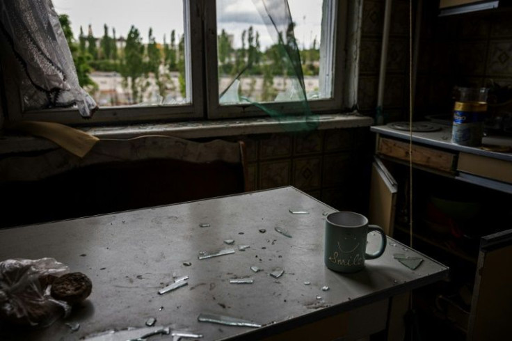 Cashier Iana, 49, and her husband contemplate the damage to their flat