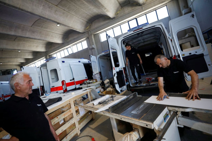 Carpenter Izet Bytyci cuts a board as he prepares to install it in a van at a workshop that manufactures ambulances in Tirana, Albania May 17, 2022.