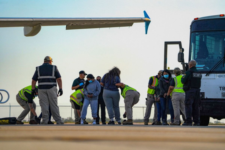 A migrant is pat-down before boarding a removal flight to Guatemala after she was determined not to have a legal basis to stay in the U.S., at Valley International Airport in Harlingen, Texas, U.S. May 17, 2022.  