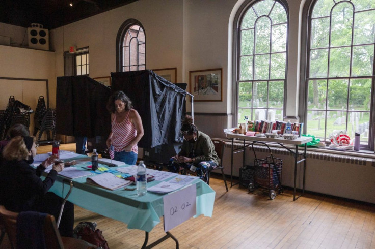 Poll workers wait to sign in voters for the Pennsylvania primary elections, at a polling place in the Gloria Dei Old Swedes Episcopal Church in Philadelphia, Pennsylvania, U.S., May 17, 2022. 