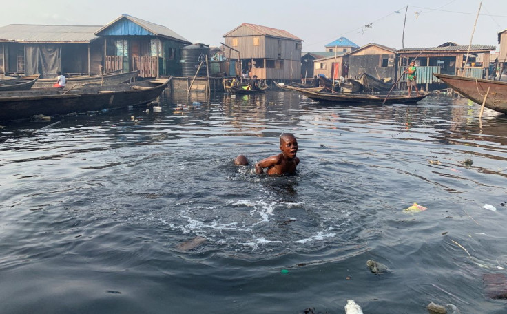 A boy swims in the polluted water of the Makoko community in Lagos, Nigeria March 9, 2020. 