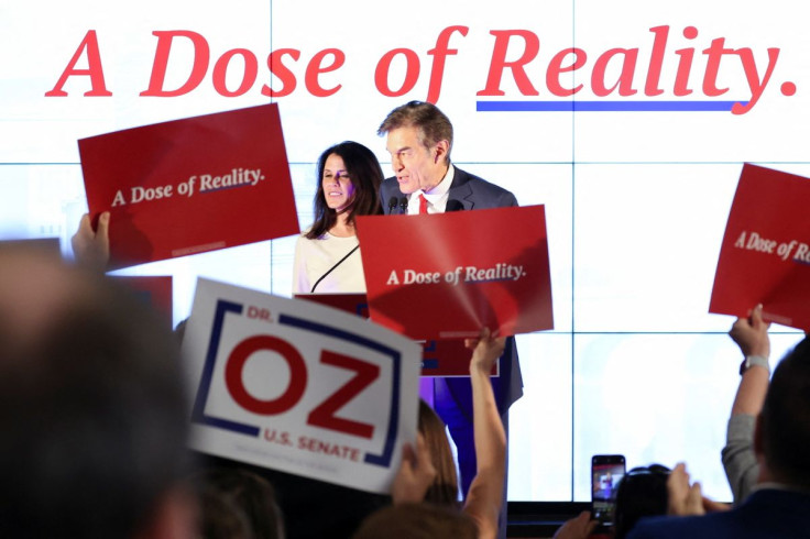 Pennsylvania Republican U.S. Senate candidate Dr. Mehmet Oz, flanked by wife Lisa Oz, speaks at his primary election night watch party in Newtown, Pennsylvania, U.S. May 17, 2022.