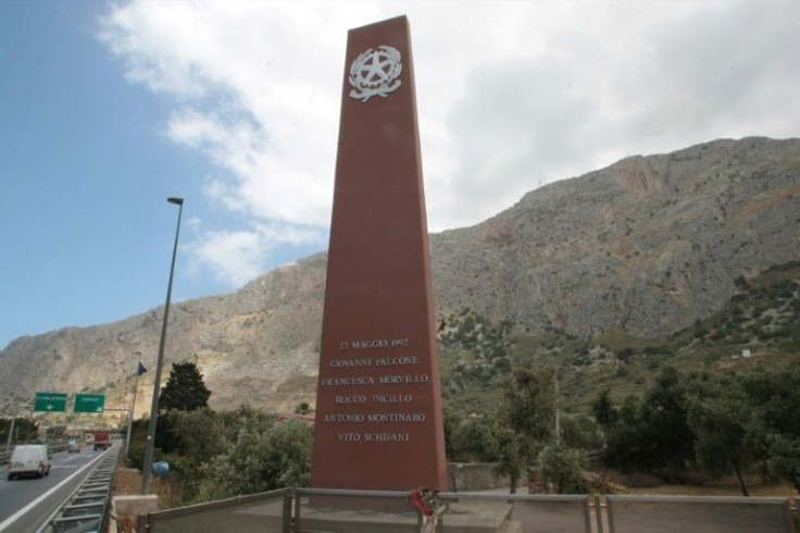 A tall red monument marks the site of the murder of Falcone, his wife and three bodyguards on the motorway from the airport