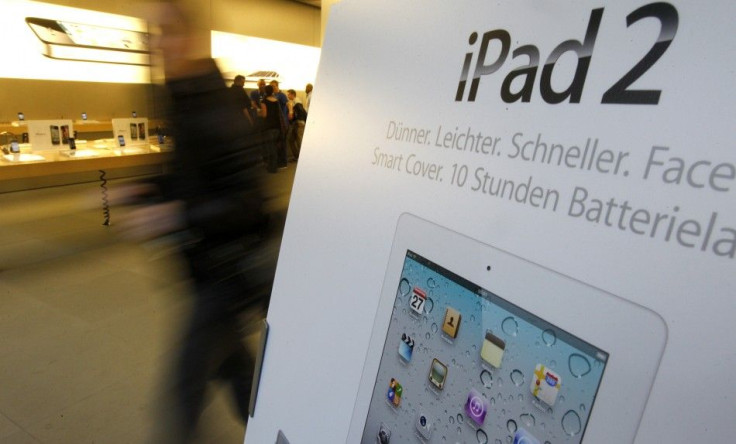 A customer walks past an advertisement for Apple&#039;s iPad 2 at Zurich&#039;s Apple store after its official launch for direct purchase in Switzerland