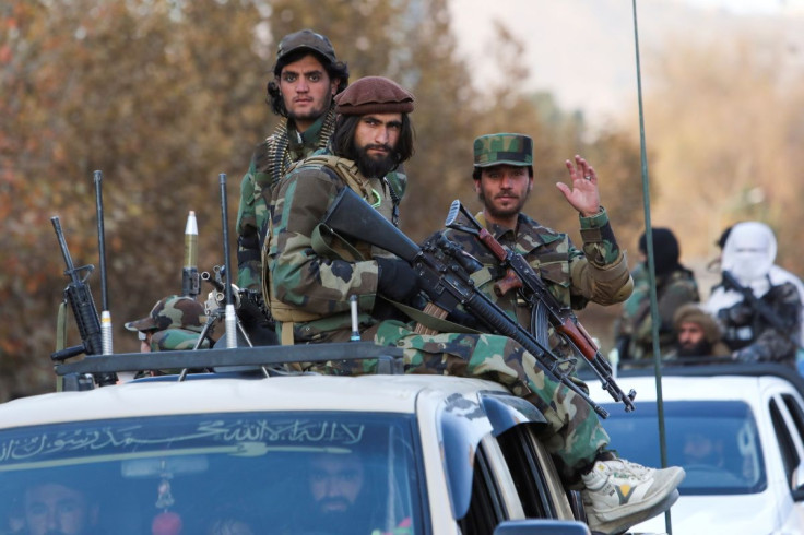 Members of Taliban sit on a military vehicle during Taliban military parade in Kabul, Afghanistan November 14, 2021.