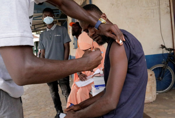 Sulayman Jalloh, an heath worker vaccinates a driver from the Bundung garage during a mobile vaccination campaign against COVID-19 in Banjul, Gambia May 11, 2022. 