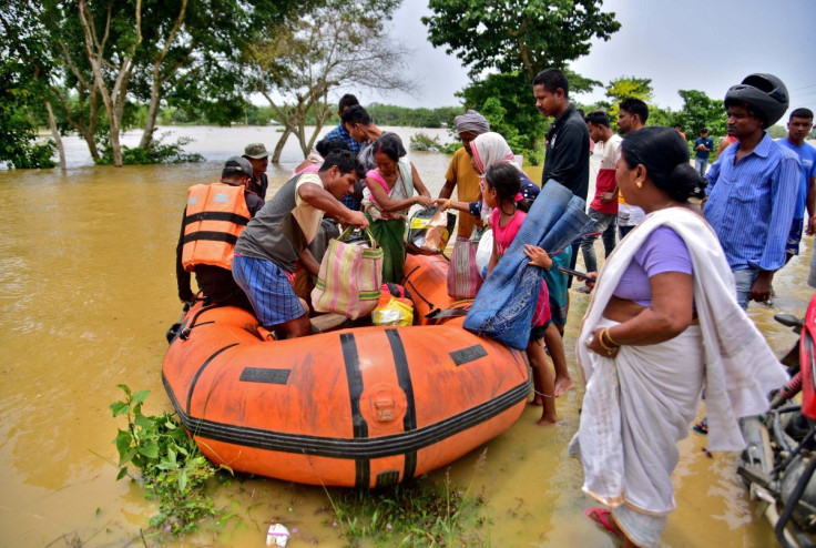 People disembark a boat after they were evacuated from a flooded village in Nagaon district, in the northeastern state of Assam, India, May 18, 2022. 