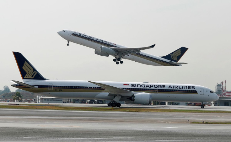 A Singapore Airlines Airbus A330-300 plane takes off behind a Boeing 787-10 Dreamliner at Changi Airport in Singapore March 28, 2018. 