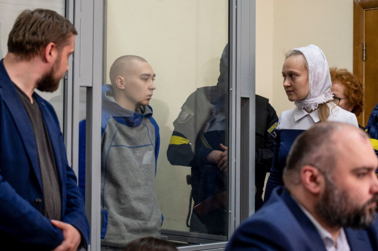 Russian soldier Vadim Shishimarin, 21, suspected of violations of the laws and norms of war, is seen inside a defendants' cage during a court hearing, amid Russia's invasion of Ukraine, in Kyiv, Ukraine May 13, 2022. 