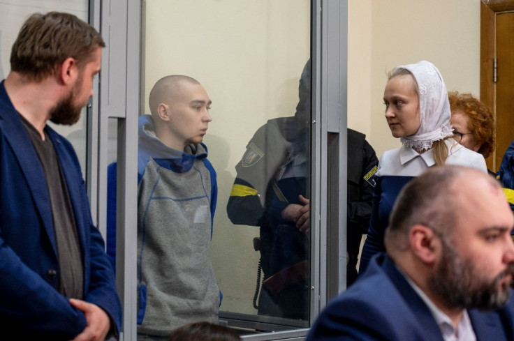Russian soldier Vadim Shishimarin, 21, suspected of violations of the laws and norms of war, is seen inside a defendants' cage during a court hearing, amid Russia's invasion of Ukraine, in Kyiv, Ukraine May 13, 2022.